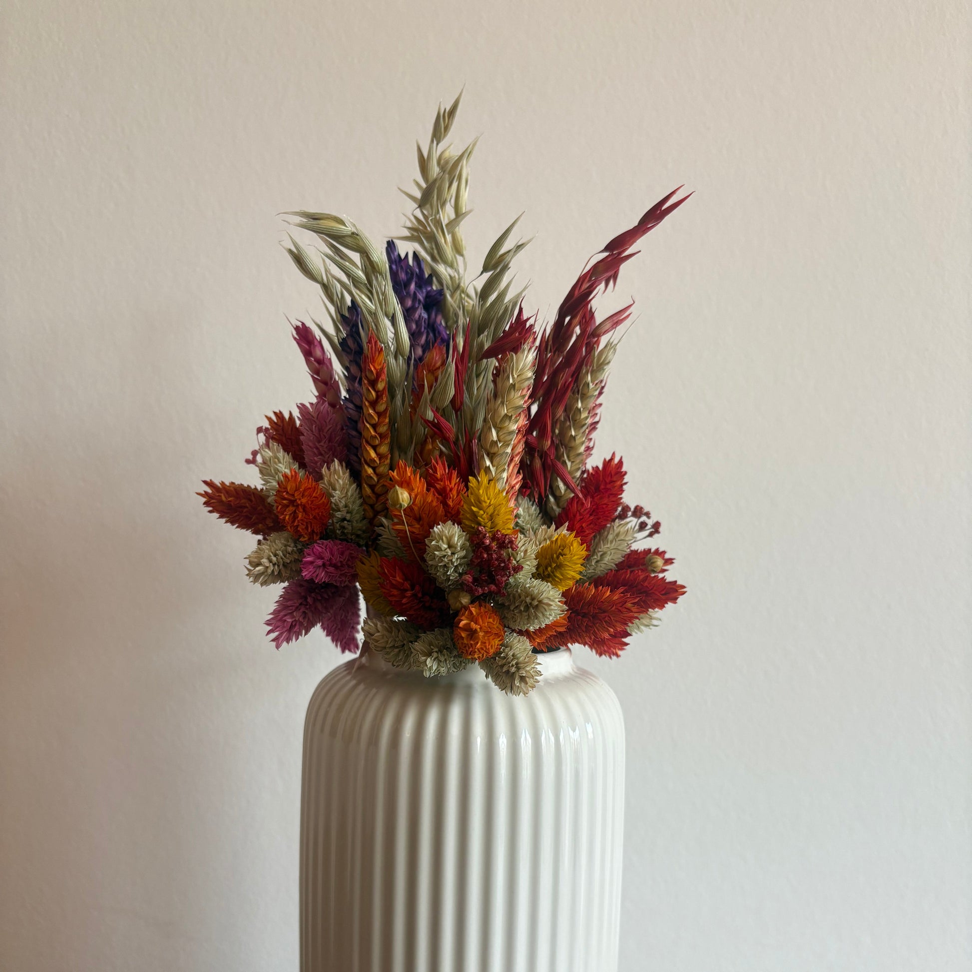 Kleine Trockenblumensträuße in einer weißen Vase